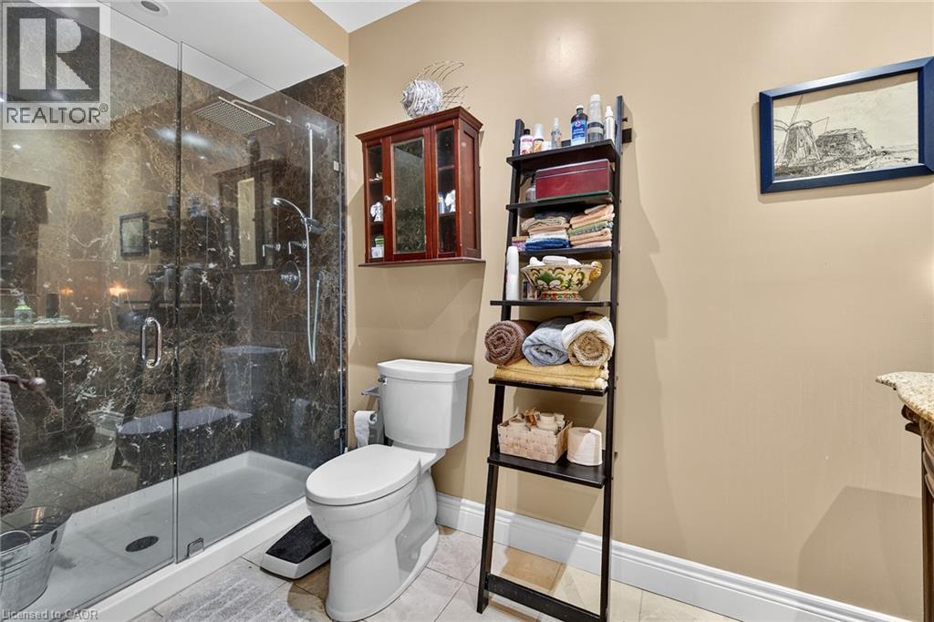Full bath with vanity, a marble finish shower, and light tile patterned floors - 5590 Blind Line, Burlington, ON - Indoor Photo Showing Bathroom