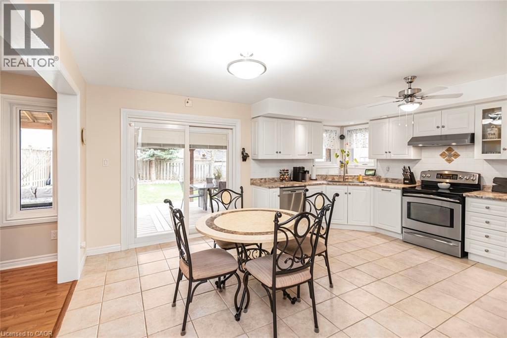 Dining room with a ceiling fan and light tile patterned floors - 40 Artistic Boulevard, Hamilton, ON - Indoor