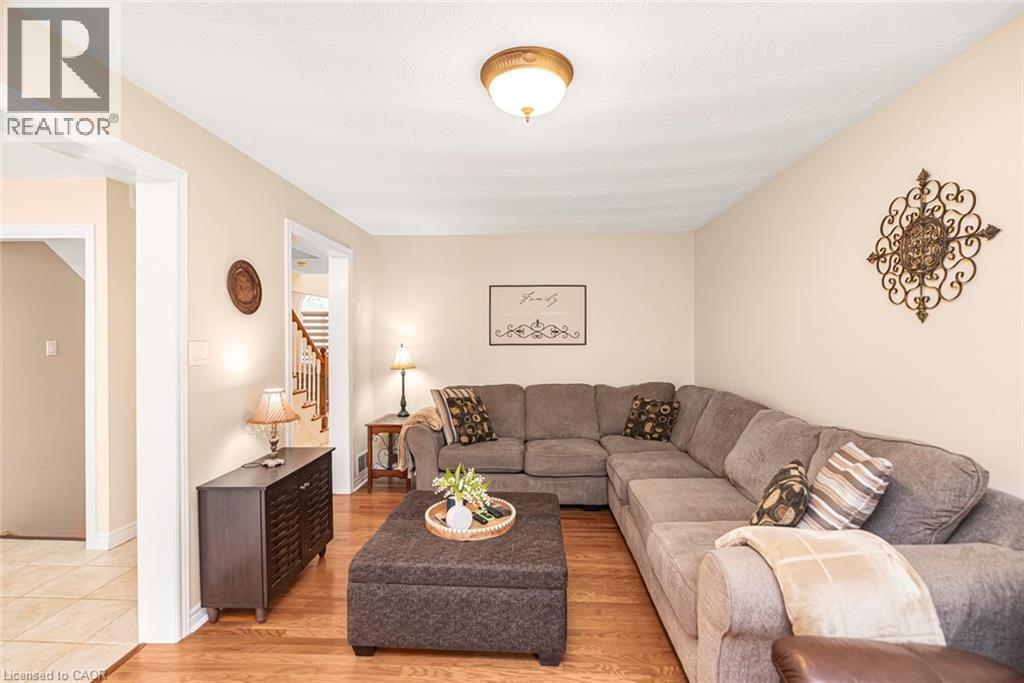 Living room with stairway and light wood-style flooring - 40 Artistic Boulevard, Hamilton, ON - Indoor Photo Showing Living Room