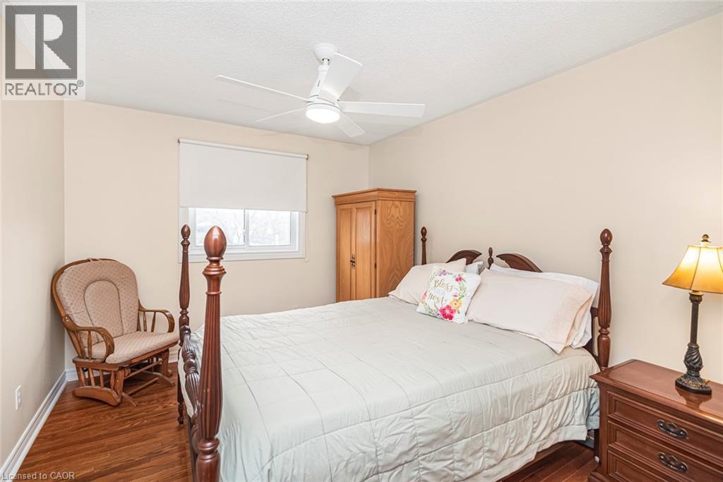 Bedroom featuring a ceiling fan, dark wood-type flooring, and a textured ceiling - 40 Artistic Boulevard, Hamilton, ON - Indoor Photo Showing Bedroom