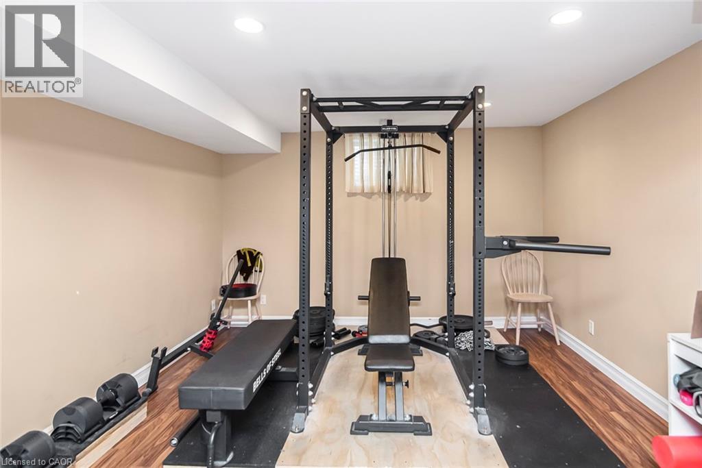 Workout area with light wood-style floors and recessed lighting - 40 Artistic Boulevard, Hamilton, ON - Indoor Photo Showing Gym Room