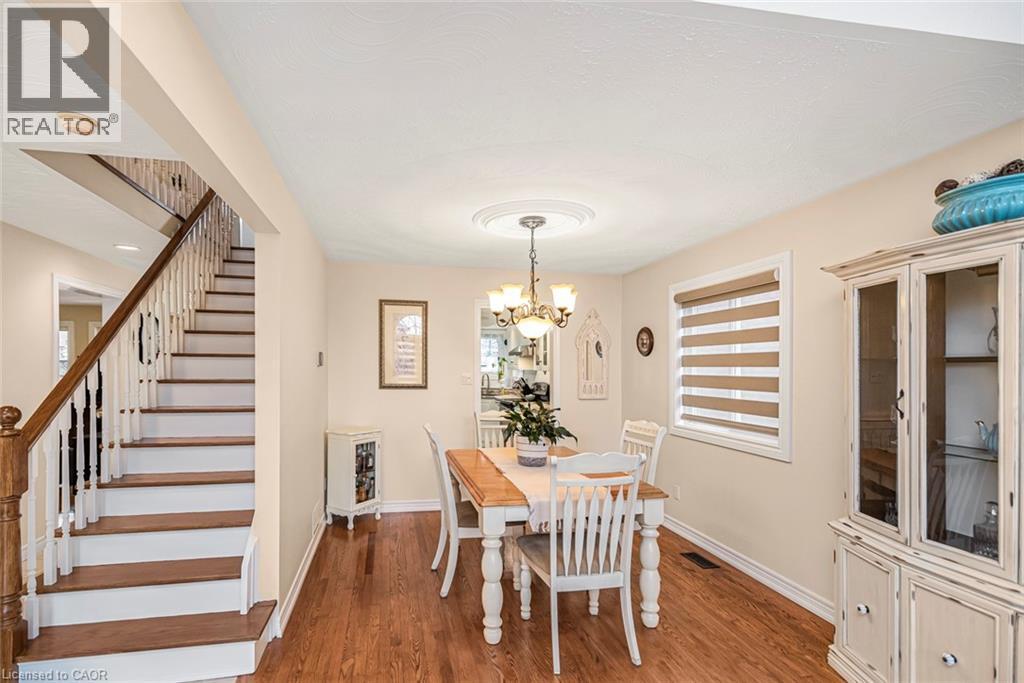 Dining room featuring wood finished floors and suspended lighting - 40 Artistic Boulevard, Hamilton, ON - Indoor Photo Showing Dining Room