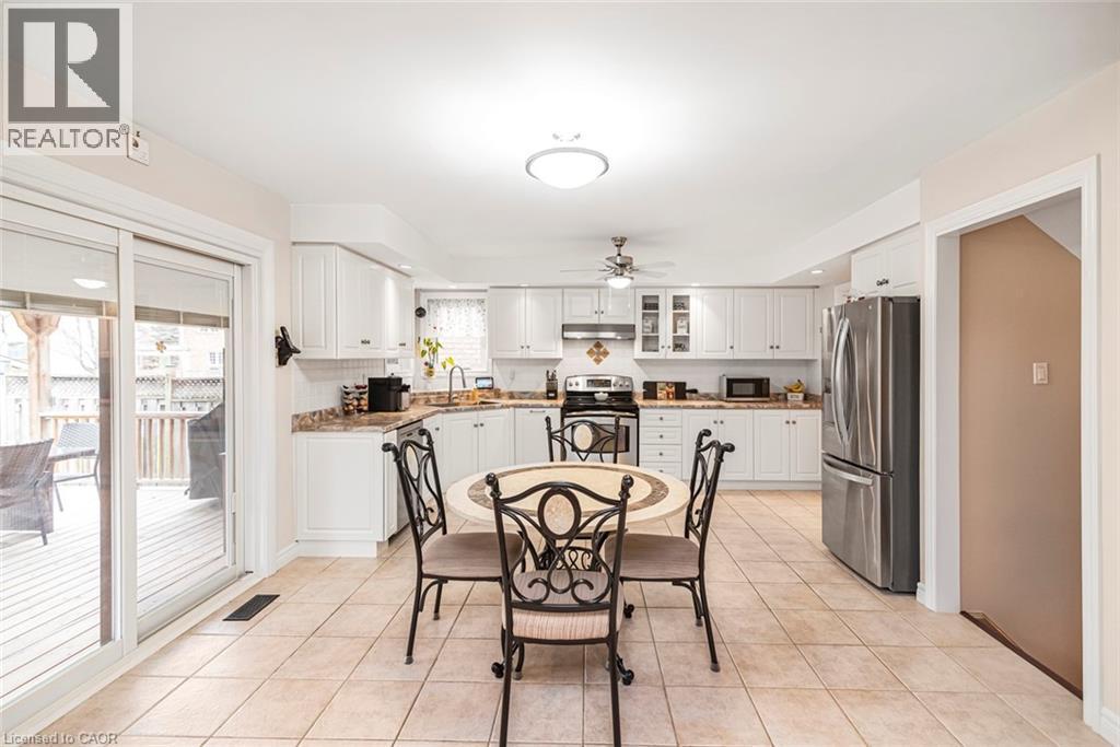 Dining area featuring ceiling fan and light tile patterned floors - 40 Artistic Boulevard, Hamilton, ON - Indoor