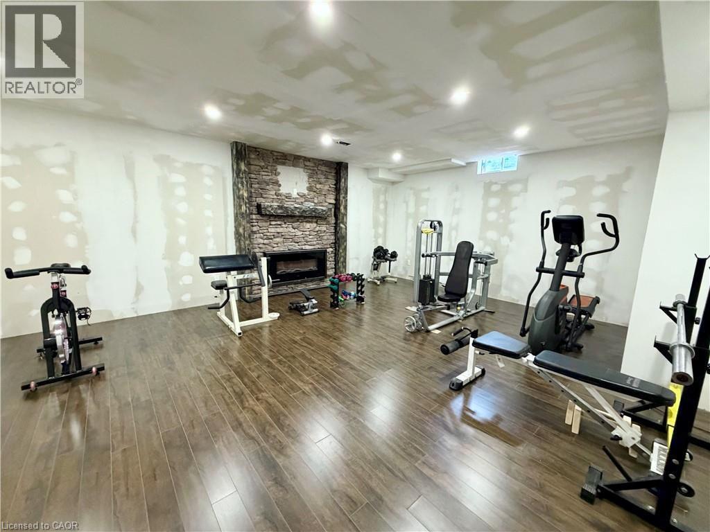 9 ft ceilings in basement. Fitness room with stone fireplace - 182 Irwin Avenue, Hamilton, ON - Indoor Photo Showing Gym Room