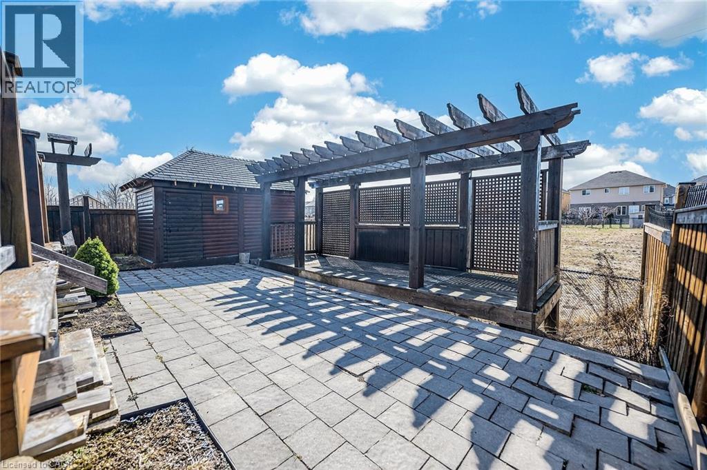 Fenced backyard featuring a patio area, a pergola, and a shed - 182 Irwin Avenue, Hamilton, ON - Outdoor