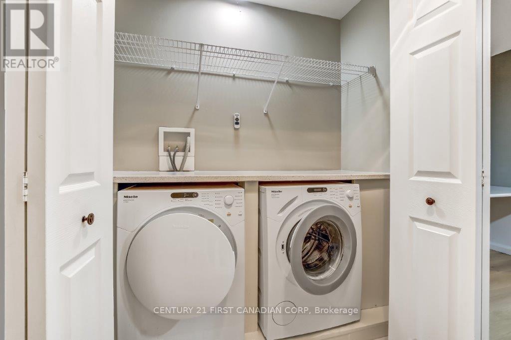 Upper hall laundry with folding table - 2 - 609 Colborne Street, London East (East F), ON - Indoor Photo Showing Laundry Room