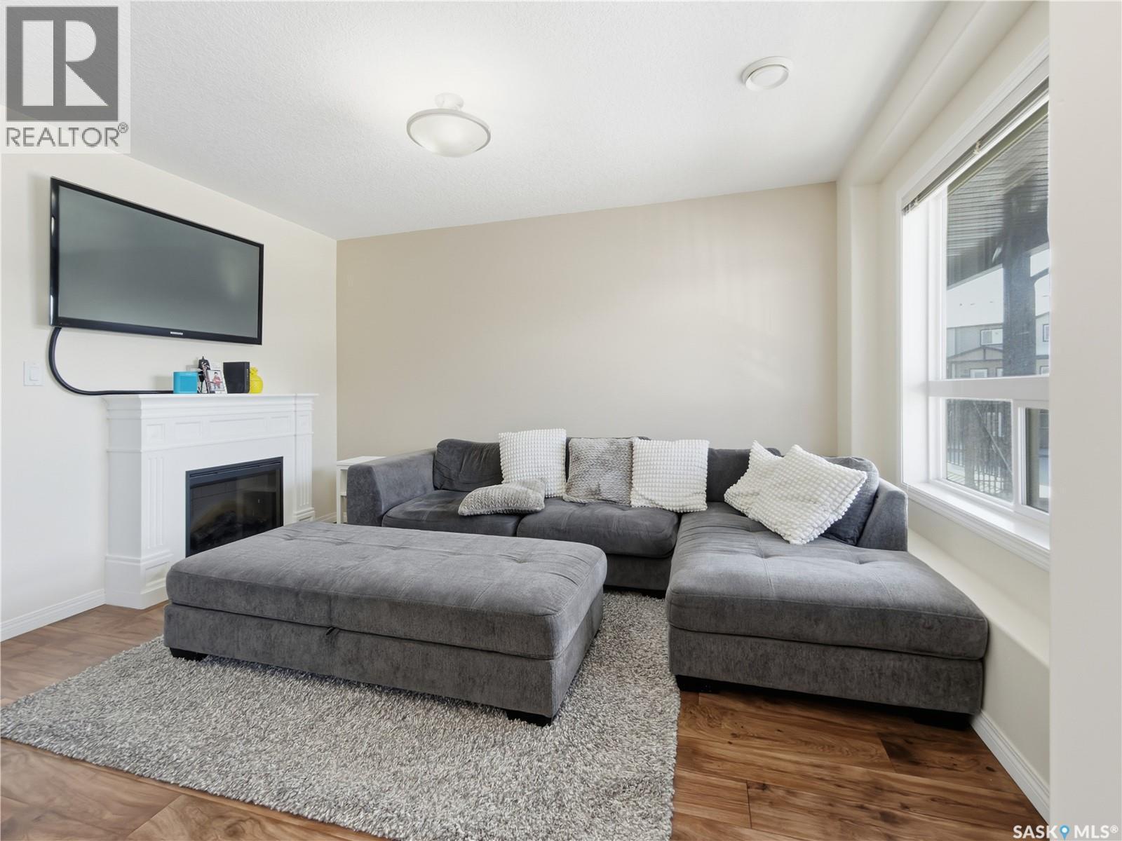 209 3818 Dewdney Avenue E, Regina, SK - Indoor Photo Showing Living Room With Fireplace