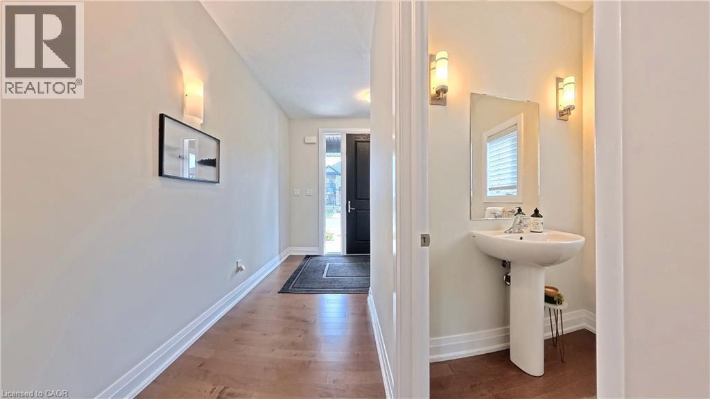 Bathroom featuring dark wood-style flooring and baseboards - 63 Ian Ormston Drive, Kitchener, ON - Indoor