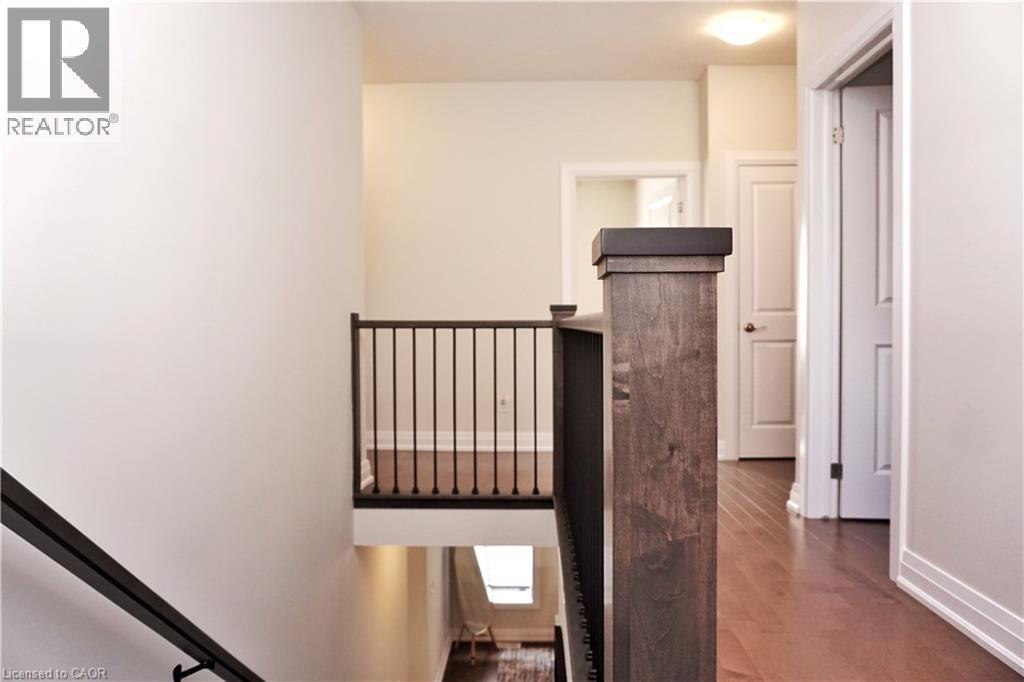 Staircase with wood finished floors and baseboards - 63 Ian Ormston Drive, Kitchener, ON - Indoor Photo Showing Other Room