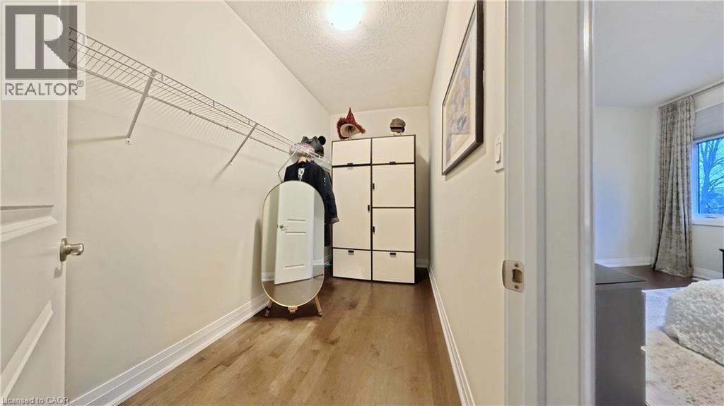 Laundry room featuring light wood finished floors and a textured ceiling - 63 Ian Ormston Drive, Kitchener, ON - Indoor