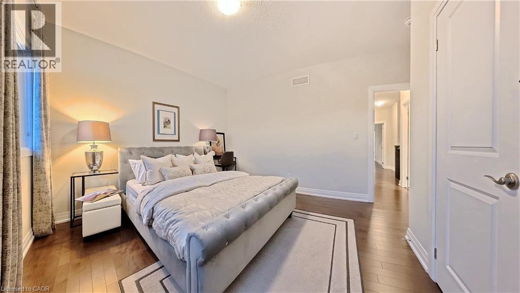 Bedroom featuring dark wood-style floors - 63 Ian Ormston Drive, Kitchener, ON - Indoor Photo Showing Bedroom