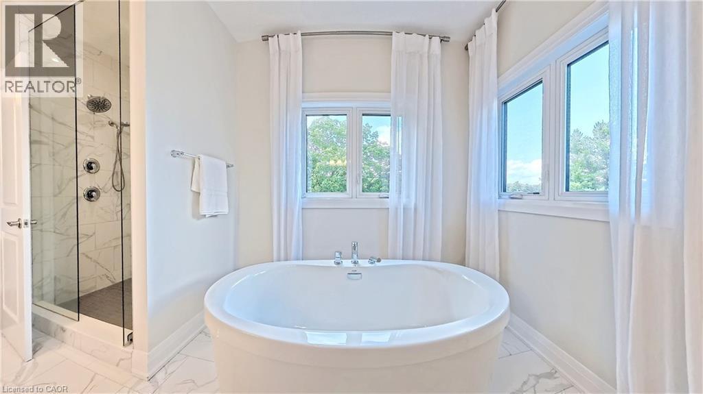 Bathroom with a marble finish shower, a freestanding bath, and light marble finish floors - 63 Ian Ormston Drive, Kitchener, ON - Indoor Photo Showing Bathroom