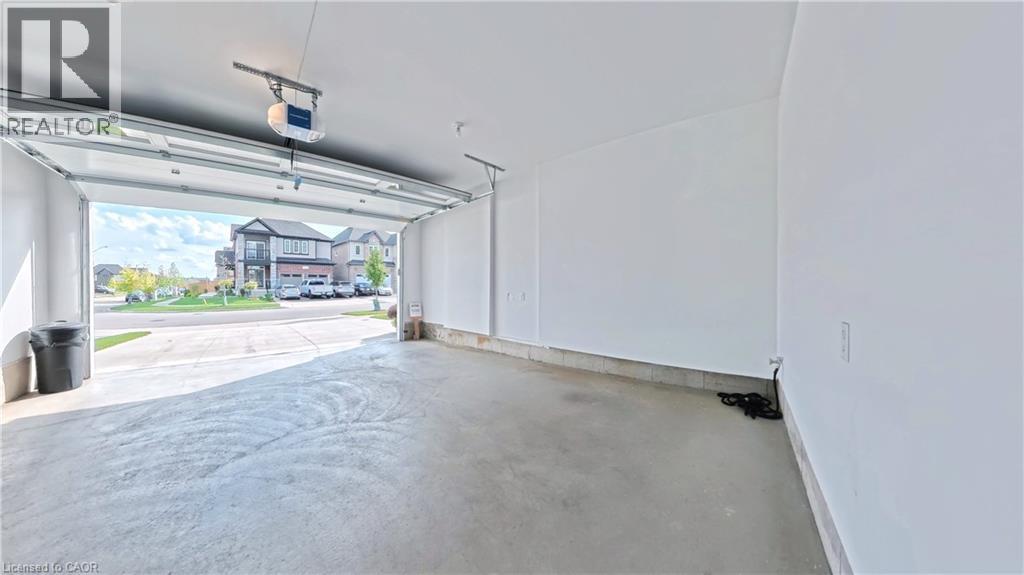 Garage featuring a garage door opener - 63 Ian Ormston Drive, Kitchener, ON - Indoor Photo Showing Garage