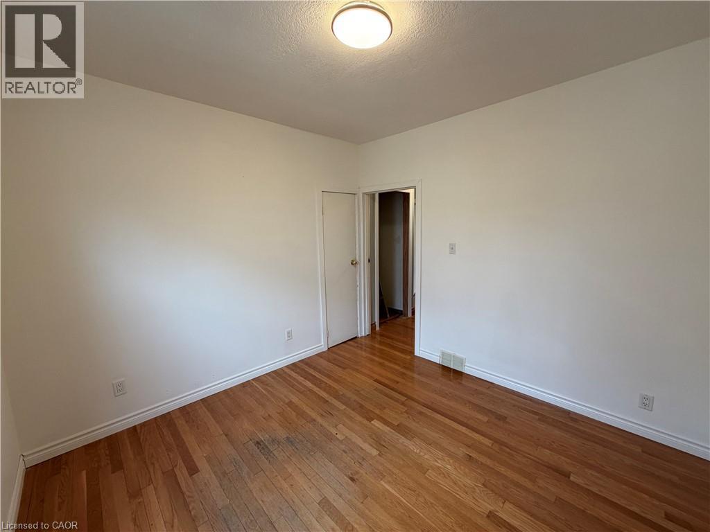 Unfurnished room with hardwood / wood-style floors and a textured ceiling - 628 Dunn Avenue, Hamilton, ON - Indoor Photo Showing Other Room
