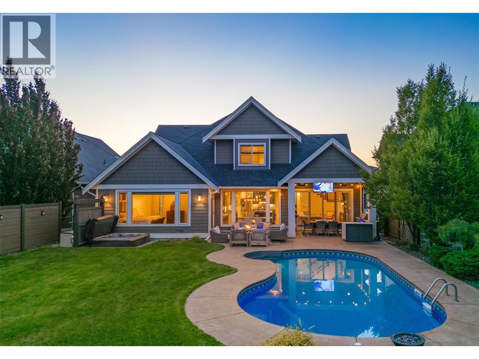 Walk from your main level right out to your amazing backyard ...watch the kids play from your kitchen! - 425 Audubon Court, Kelowna, BC - Outdoor With In Ground Pool With Deck Patio Veranda