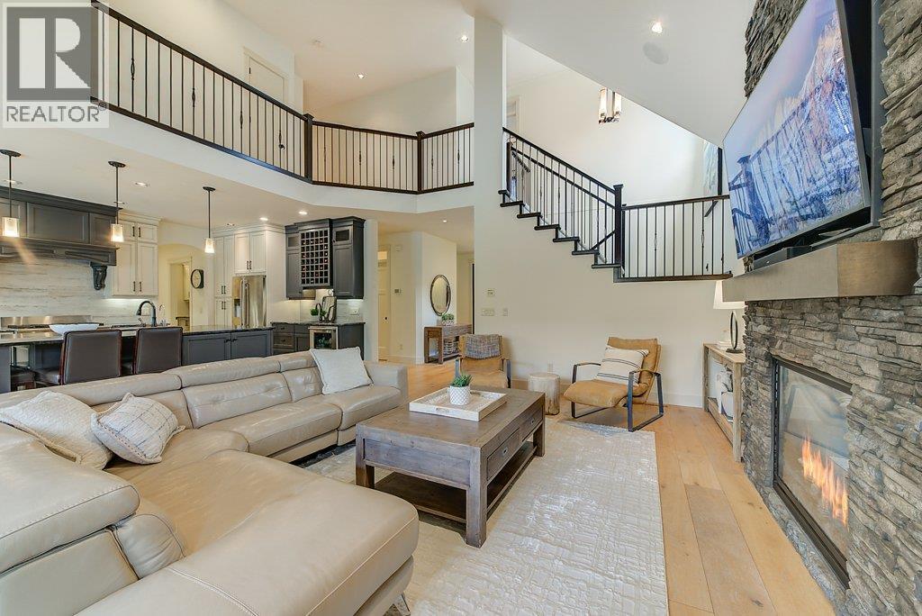 Gorgeous great room with soaring ceilings! - 425 Audubon Court, Kelowna, BC - Indoor Photo Showing Living Room With Fireplace