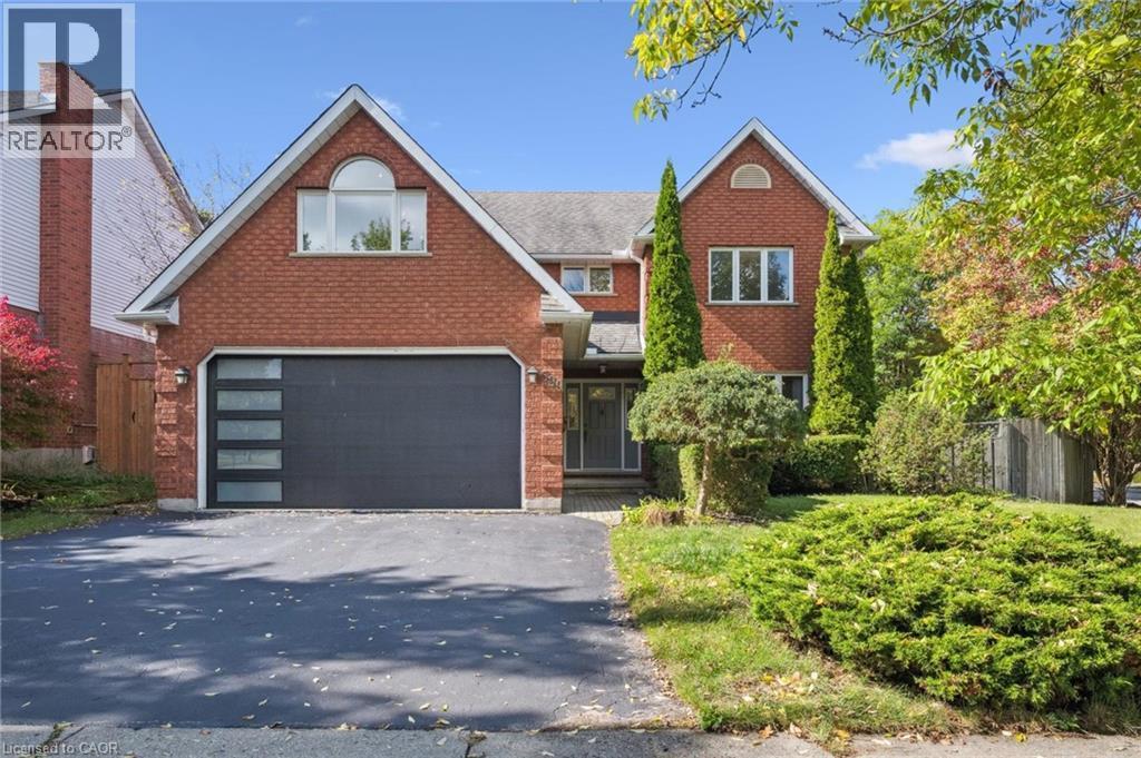 View of front facade featuring brick siding, a garage, and driveway - 599 Beechwood Drive, Waterloo, ON - Outdoor
