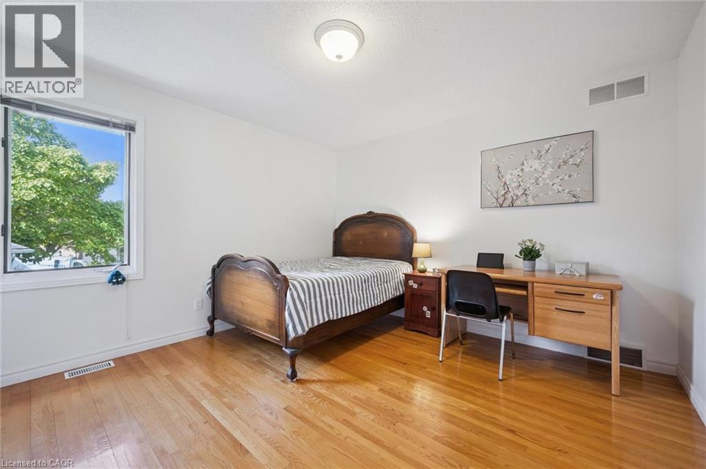 Bedroom with light wood-style floors, an office area, and a textured ceiling - 599 Beechwood Drive, Waterloo, ON - Indoor Photo Showing Bedroom