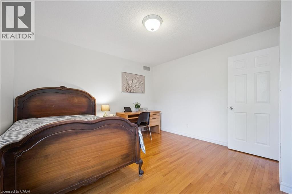 Bedroom with light wood-style flooring, an office area, and a textured ceiling - 599 Beechwood Drive, Waterloo, ON - Indoor Photo Showing Bedroom