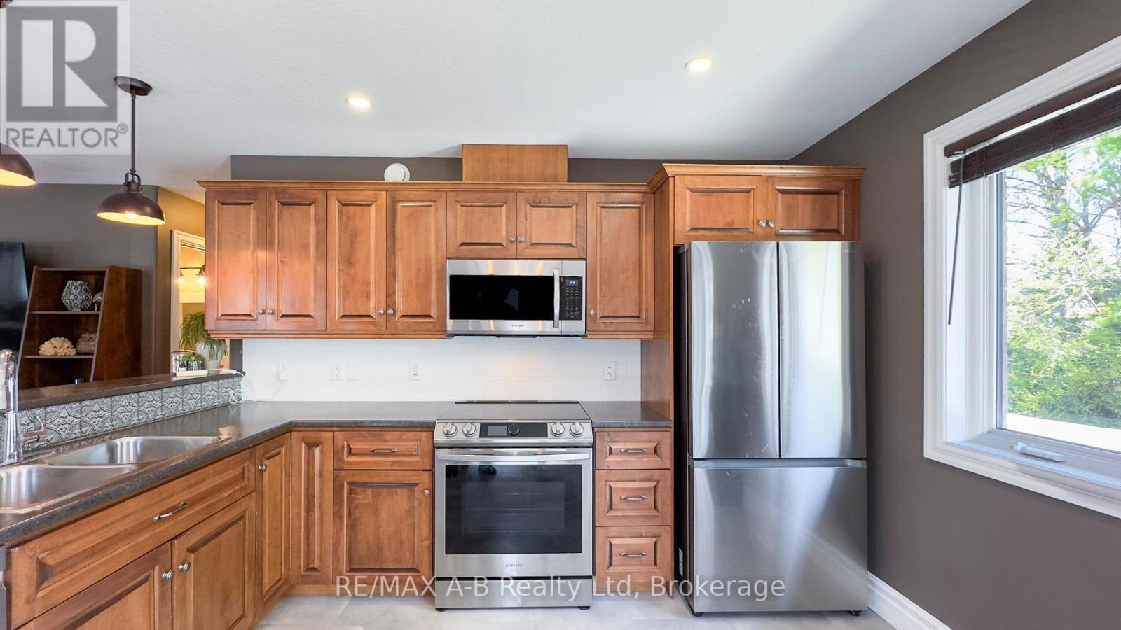 83 Sylvia Street, West Perth (Mitchell), ON - Indoor Photo Showing Kitchen With Double Sink