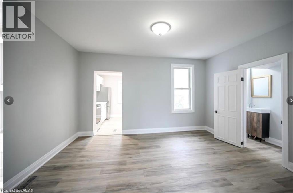 Unfurnished bedroom with wood finished floors and baseboards - 1024 Cannon Street E, Hamilton, ON - Indoor Photo Showing Other Room