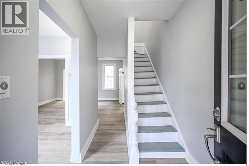 Stairway with wood finished floors and baseboards - 1024 Cannon Street E, Hamilton, ON - Indoor Photo Showing Other Room