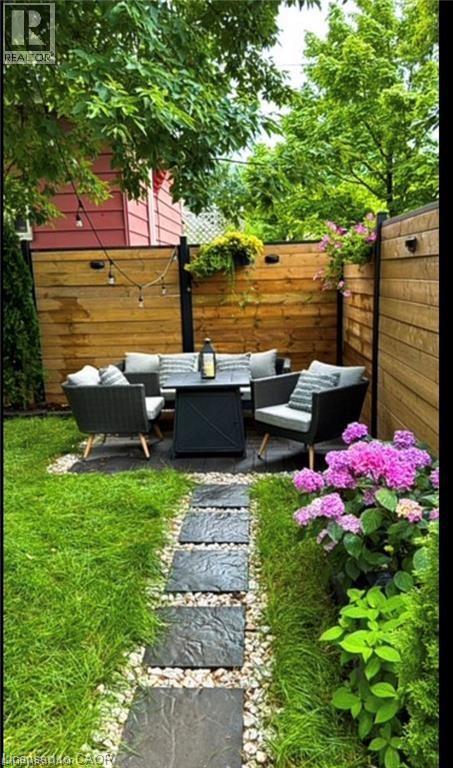Fenced backyard with outdoor lounge area and a patio area - 1024 Cannon Street E, Hamilton, ON - Outdoor