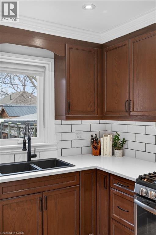 Kitchen featuring gas range, tasteful backsplash, and recessed lighting - 248 London Street S, Hamilton, ON - Indoor Photo Showing Kitchen With Double Sink
