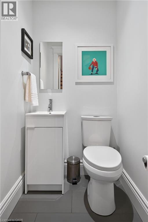 Half bath with vanity and tile patterned floors - 248 London Street S, Hamilton, ON - Indoor Photo Showing Bathroom