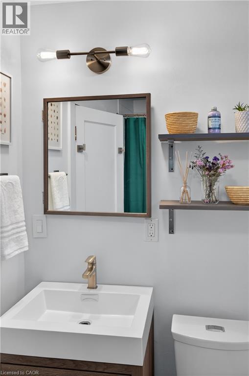 Full bath featuring vanity and a shower with shower curtain - 248 London Street S, Hamilton, ON - Indoor Photo Showing Bathroom