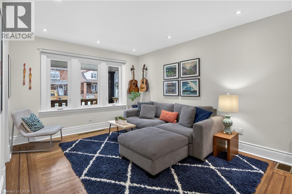 Living area featuring wood finished floors and recessed lighting - 248 London Street S, Hamilton, ON - Indoor Photo Showing Living Room