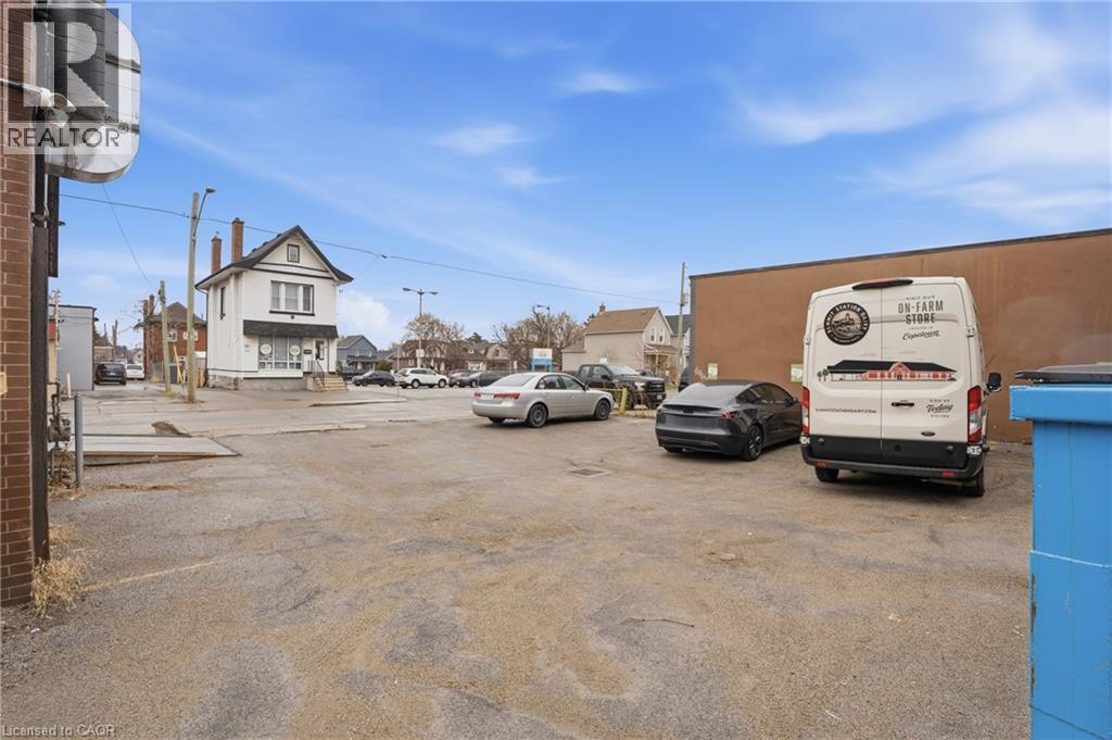 Uncovered parking lot featuring a residential view - 204 Ottawa Street N, Hamilton, ON