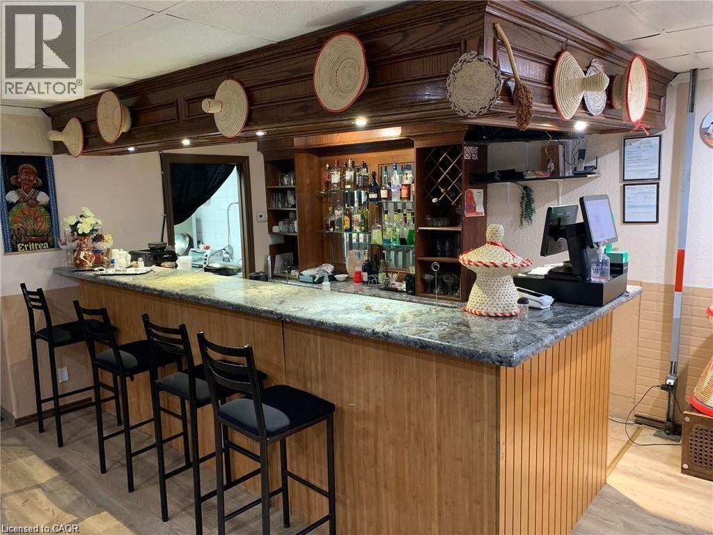 Bar featuring dark stone countertops - 347 Lancaster Street W, Kitchener, ON