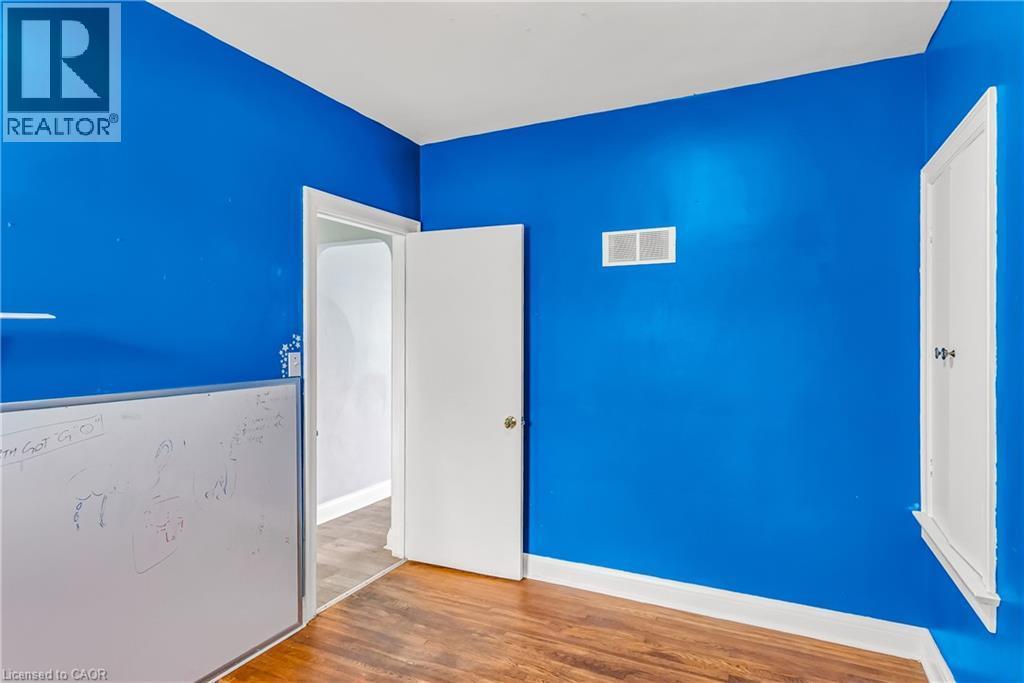 Unfurnished bedroom with light wood-style floors and baseboards - 41 Floral Crescent, Kitchener, ON - Indoor Photo Showing Other Room
