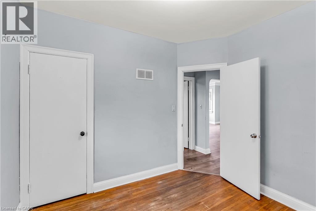 Unfurnished bedroom with baseboards and wood finished floors - 41 Floral Crescent, Kitchener, ON - Indoor Photo Showing Other Room