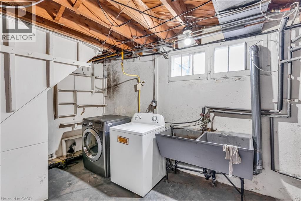 Laundry area featuring concrete flooring and washer and dryer - 41 Floral Crescent, Kitchener, ON - Indoor Photo Showing Laundry Room