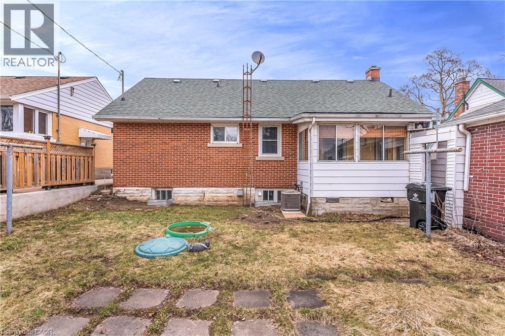 Rear view of property with roof with shingles, brick siding, and a chimney - 41 Floral Crescent, Kitchener, ON - Outdoor
