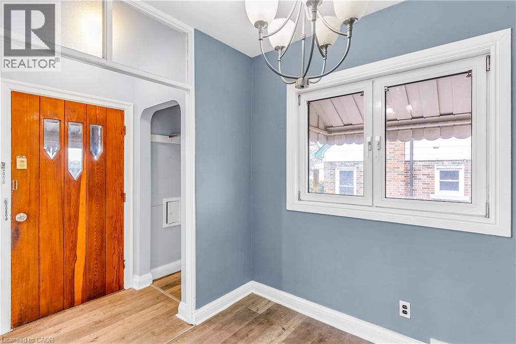 Foyer entrance featuring a chandelier, light wood-type flooring, and arched walkways - 41 Floral Crescent, Kitchener, ON - Indoor Photo Showing Other Room