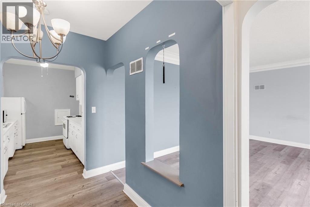 Full bathroom with light wood finished floors, vanity, and hanging lights - 41 Floral Crescent, Kitchener, ON - Indoor Photo Showing Other Room