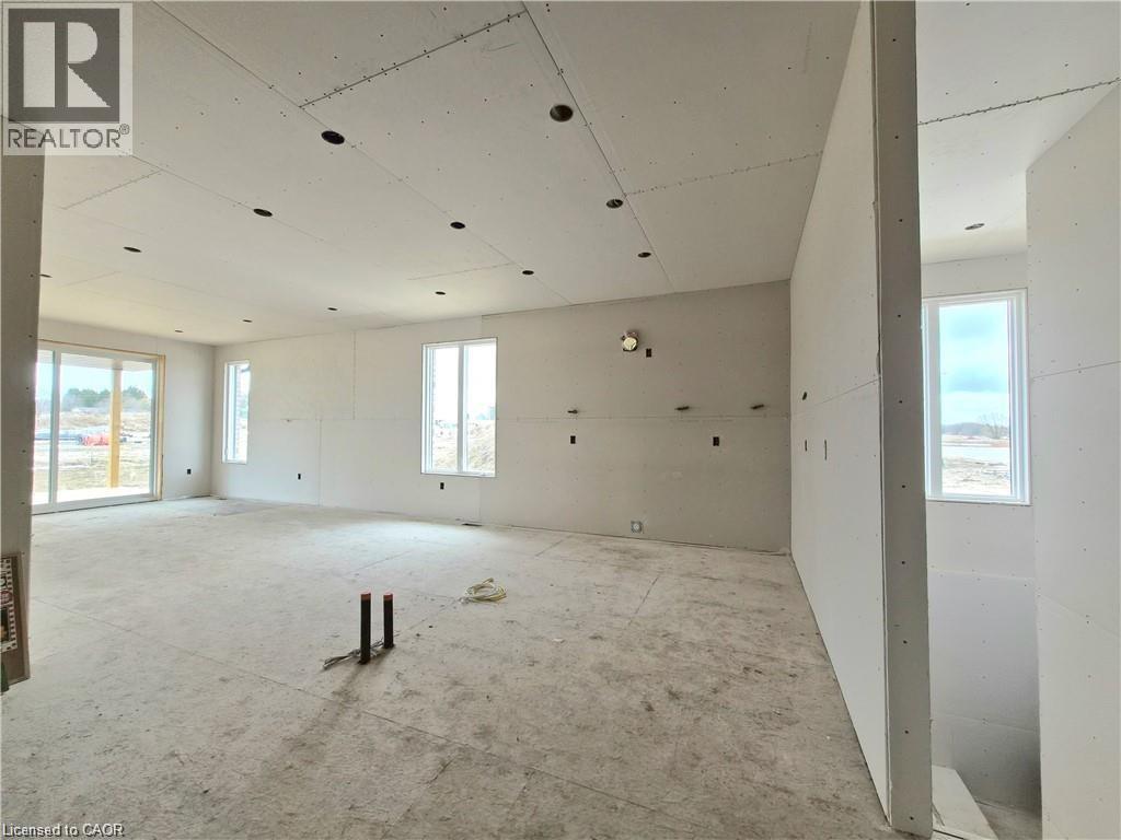Spare room featuring plenty of natural light - 106 Thackeray Way, Harriston, ON - Indoor Photo Showing Garage