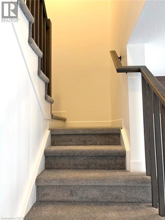 Stairway with carpet floors - 7 Pin Oak Common, Cambridge, ON - Indoor Photo Showing Other Room