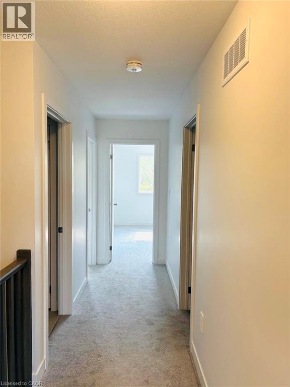 Hall with light carpet and baseboards - 7 Pin Oak Common, Cambridge, ON - Indoor Photo Showing Other Room