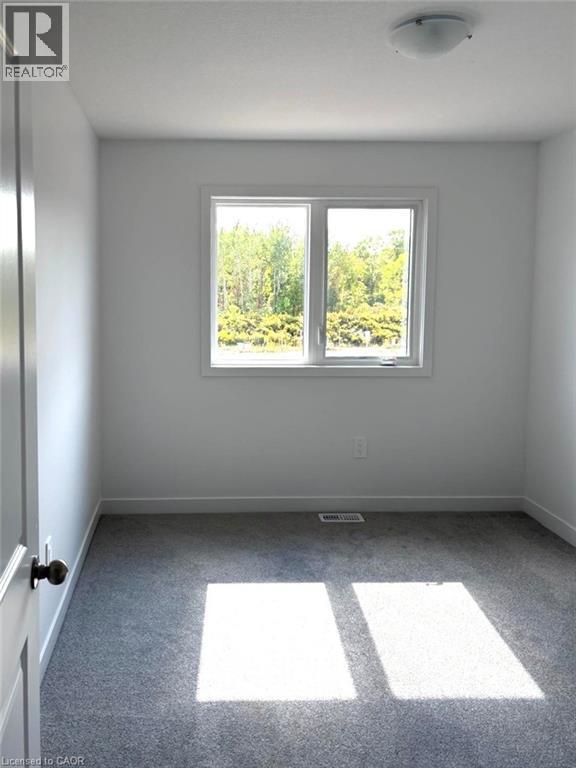 Unfurnished room featuring light carpet and baseboards - 7 Pin Oak Common, Cambridge, ON - Indoor Photo Showing Other Room
