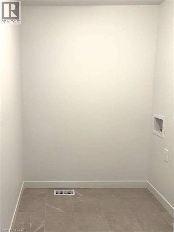 Laundry room featuring baseboards and washer hookup - 7 Pin Oak Common, Cambridge, ON - Indoor Photo Showing Other Room