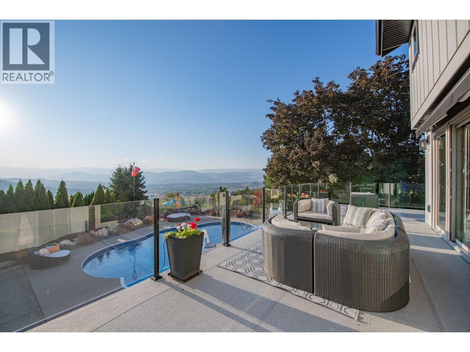 Fabulous large deck with retractable awning - 702 Cypress Drive, Coldstream, BC - Outdoor With In Ground Pool