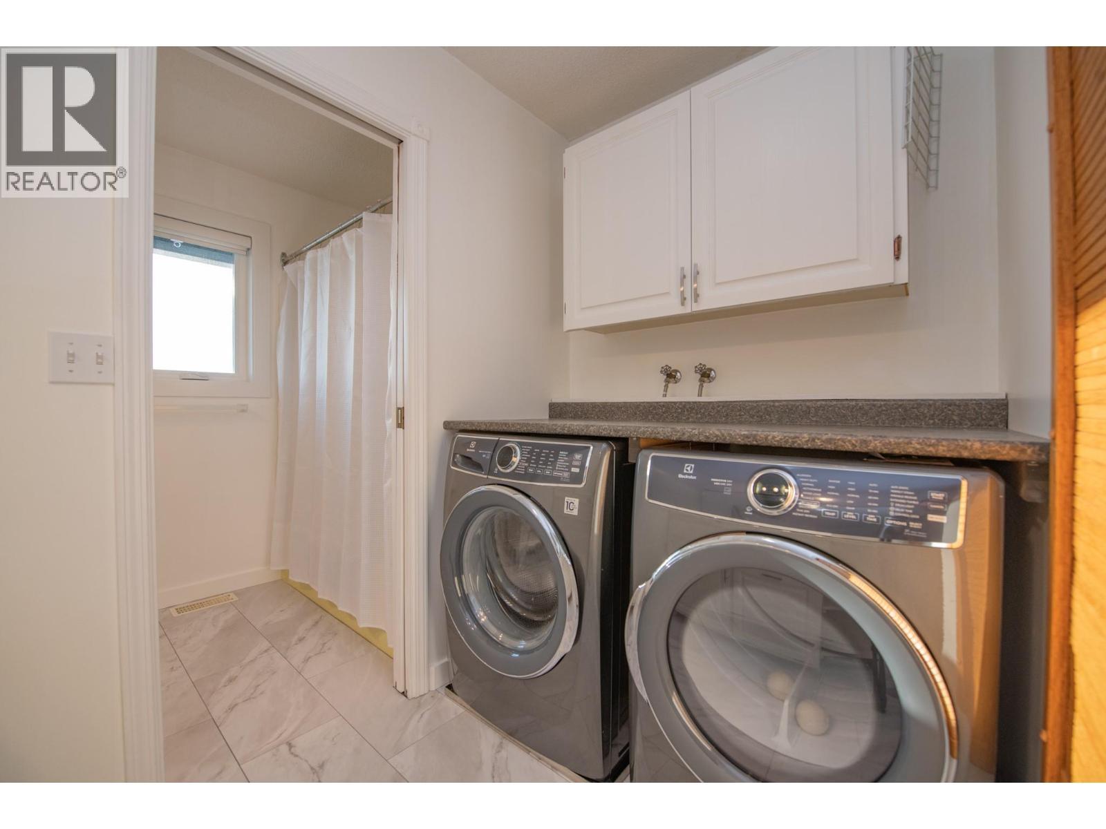 Laundry Room and Full Bath Upstairs - 702 Cypress Drive, Coldstream, BC - Indoor Photo Showing Laundry Room