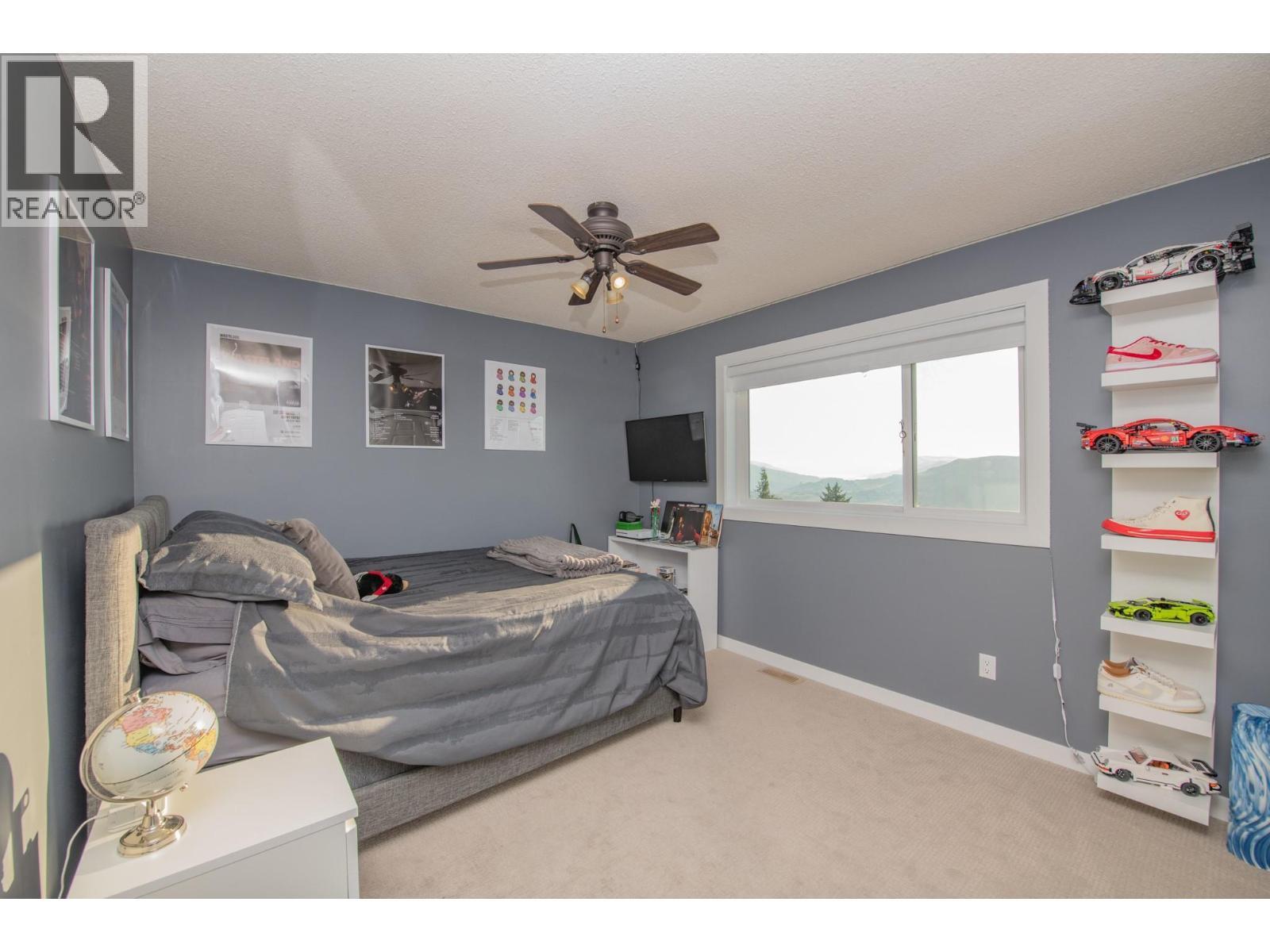 3 of 4 bedrooms upstairs - 702 Cypress Drive, Coldstream, BC - Indoor Photo Showing Bedroom