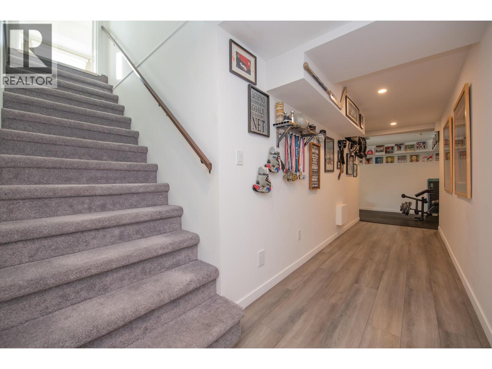 Stairs from kitchen to lower level - 702 Cypress Drive, Coldstream, BC - Indoor Photo Showing Other Room