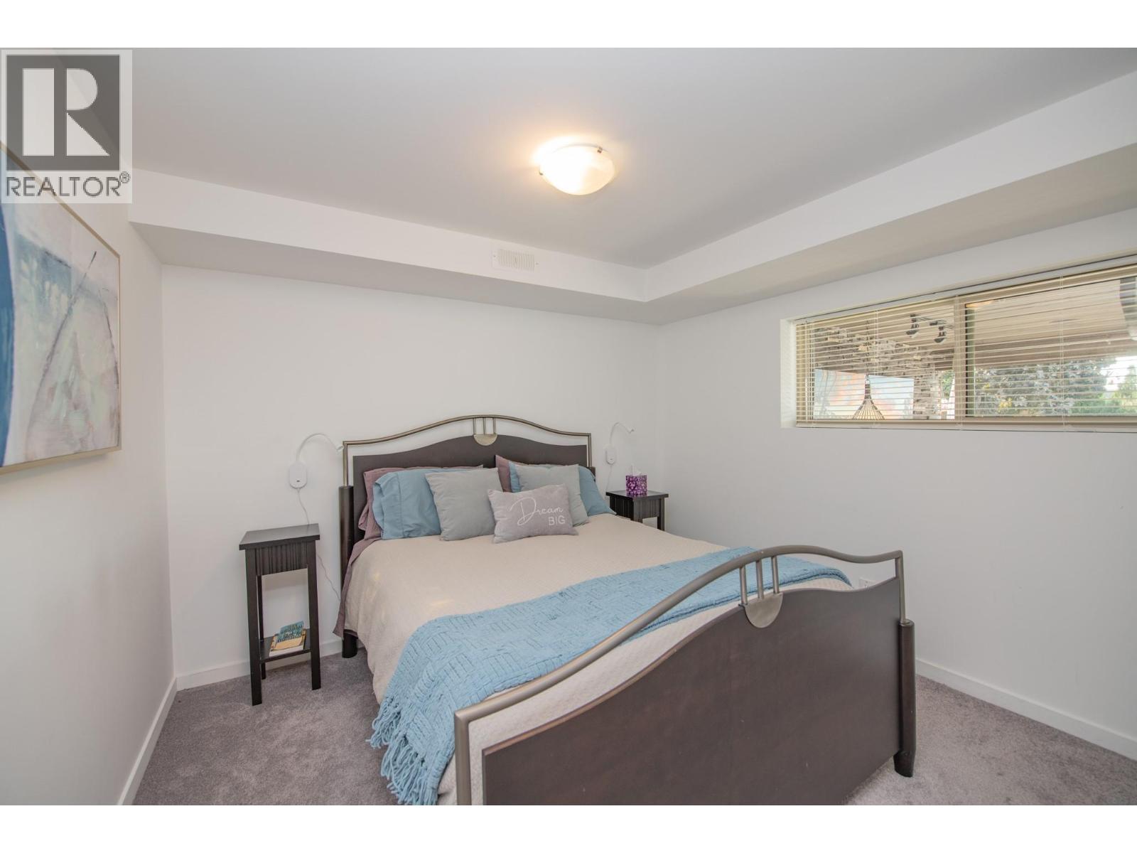 Lower bedroom - 702 Cypress Drive, Coldstream, BC - Indoor Photo Showing Bedroom