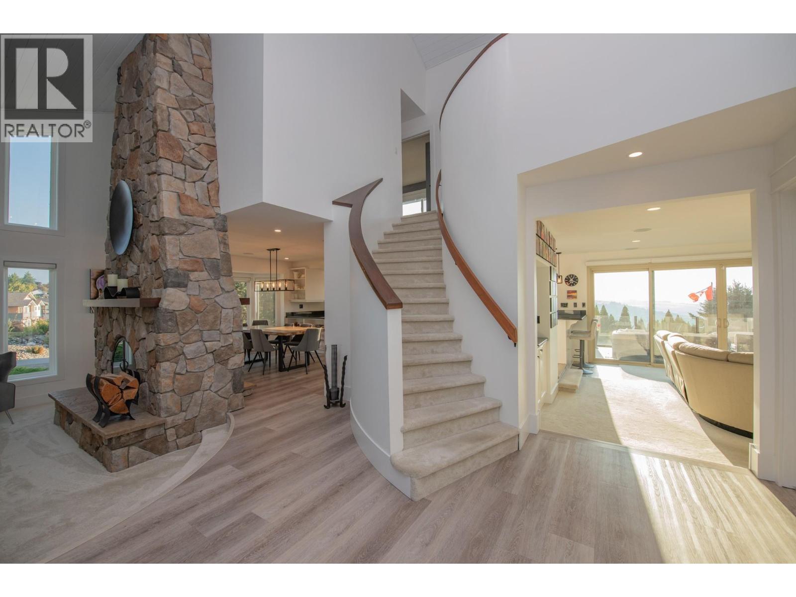 Grand entryway - 702 Cypress Drive, Coldstream, BC - Indoor Photo Showing Other Room With Fireplace